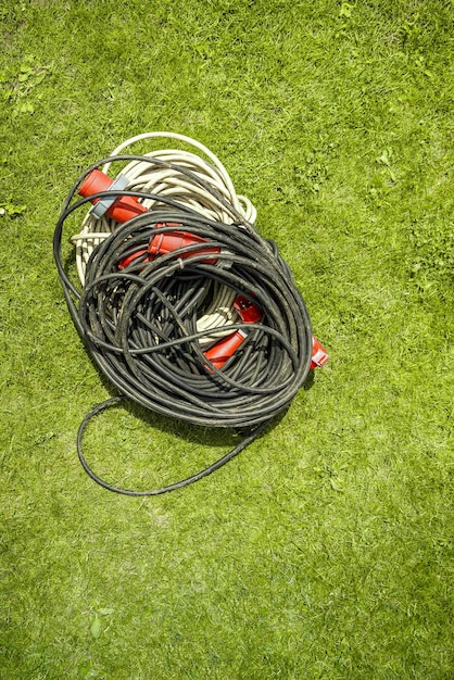 Power three phase wire extension cord for high voltage wires on grass with copy space