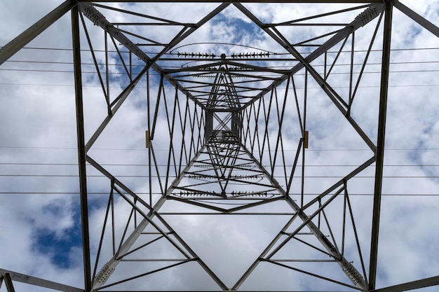 Power tower seen from below Blue sky with clouds