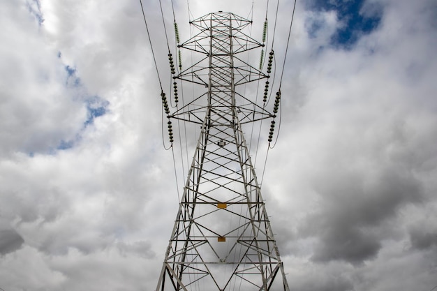 Power transmission tower with clouds in the sky