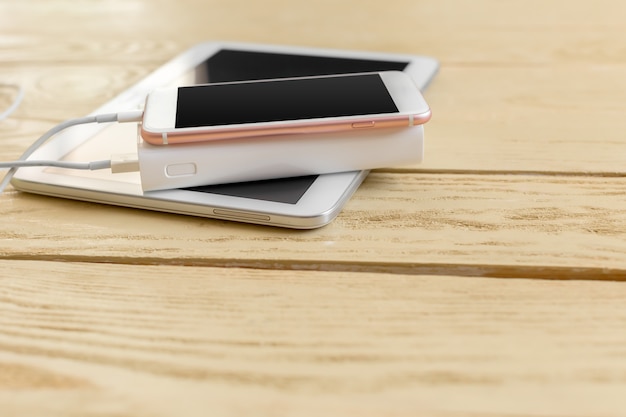 Powerbank and cellphone on wooden table