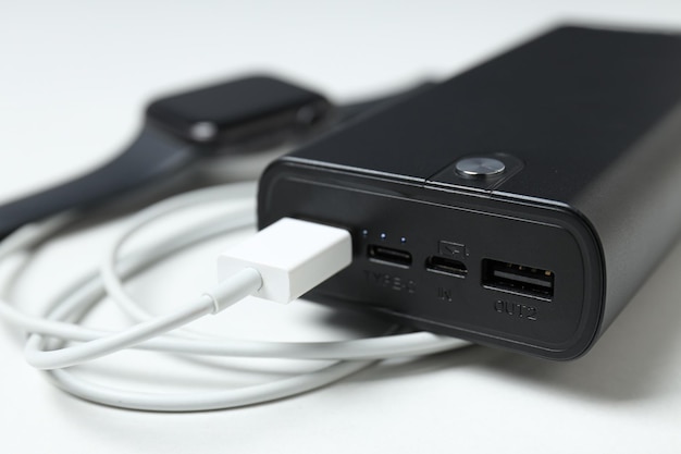 Powerbank and cord on white background close up