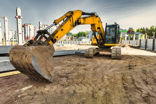 A powerful crawler excavator is working on a construction site Closeup Preparation of a pit for construction Excavation