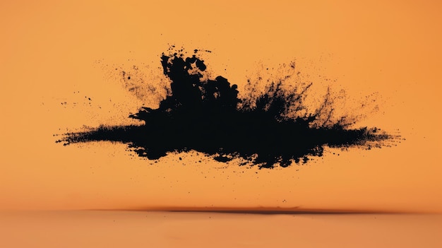 A powerful and intense explosion of black powder against an orange backdrop