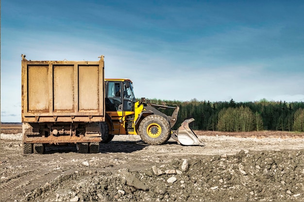 Powerful wheel loader or bulldozer working on a quarry or construction site Earthworks in construction Powerful modern equipment for earthworks