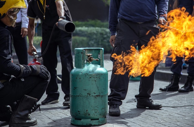 Practice Firefighters fighting a fire operation with high pressure portable