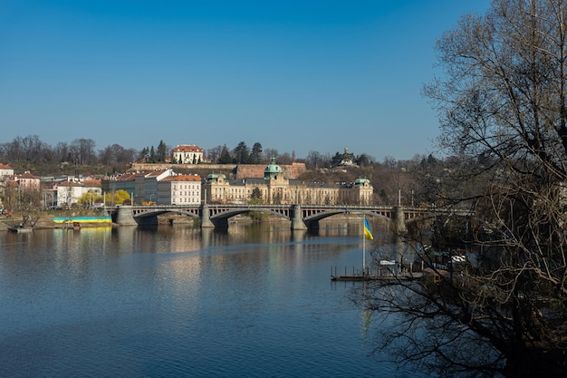 Prague Czech Republic view of the Vltava river on the Manes bridge The end of March River banks in Ukrainian flags The Czech Republic supports Ukraine in the war Russian aggression