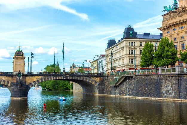 Prague embankment on a summer day. Panorama of the city. Beautiful buildings.