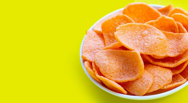 Prawn crackers on yellow background Shrimp crispy rice snack