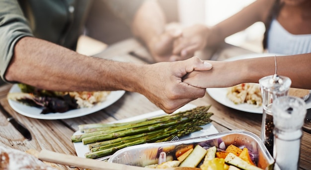 Photo prayer hands and lunch at table for faith gratitude and worship together at home closeup people and buffet in dining room for food support and healthy meal in afternoon for christianity