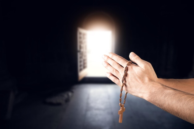 Prayer man hand cross on church background