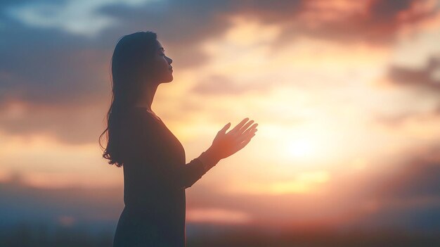 Prayer woman worship God in the morning with sunrise sky background