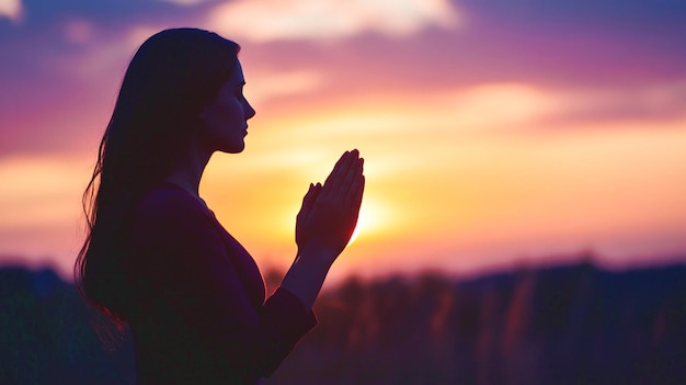 Prayer woman worship God in the morning with sunrise sky background