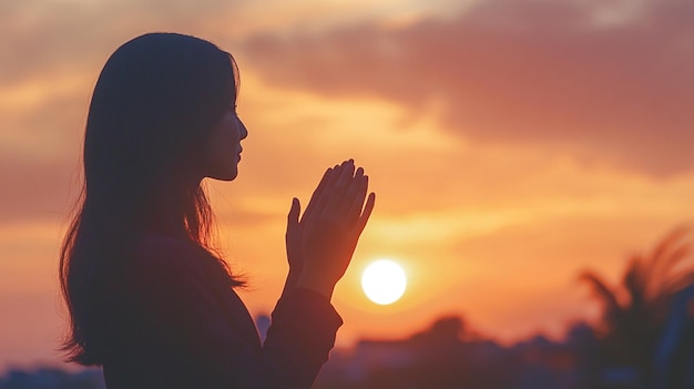 Prayer woman worship God in the morning with sunrise sky background