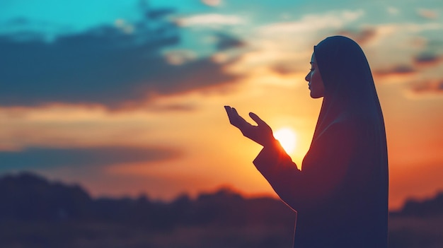 Prayer woman worship God in the morning with sunrise sky background