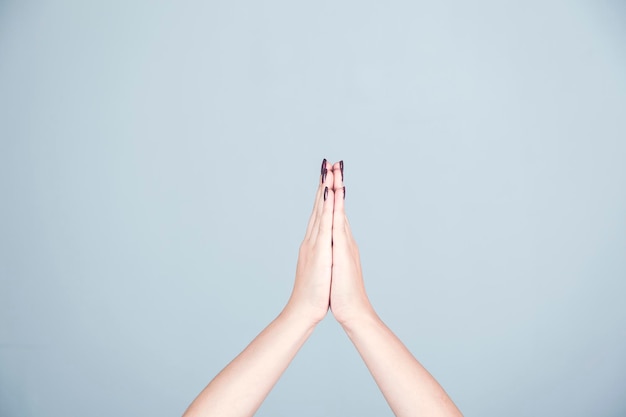 Prayerful woman on gray background