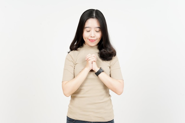 Praying Gesture Of Beautiful Asian Woman Isolated On White Background