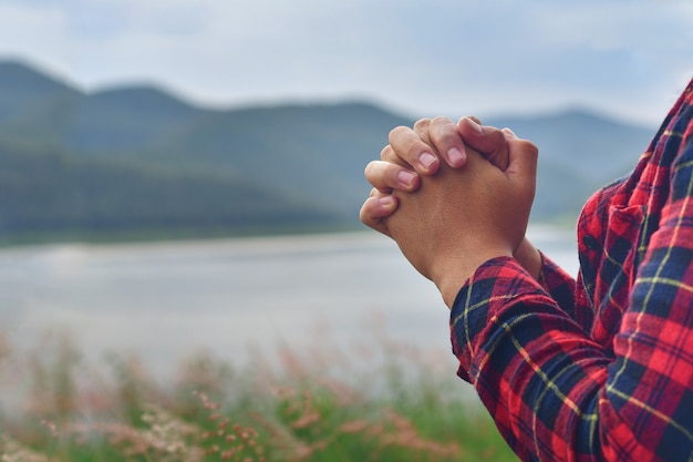 Praying hands of young man