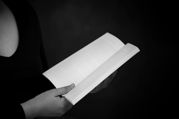 Praying and worship to GOD Using hands to pray with book  in religious beliefs and worship christian in the church or in general locations in  White and Black background