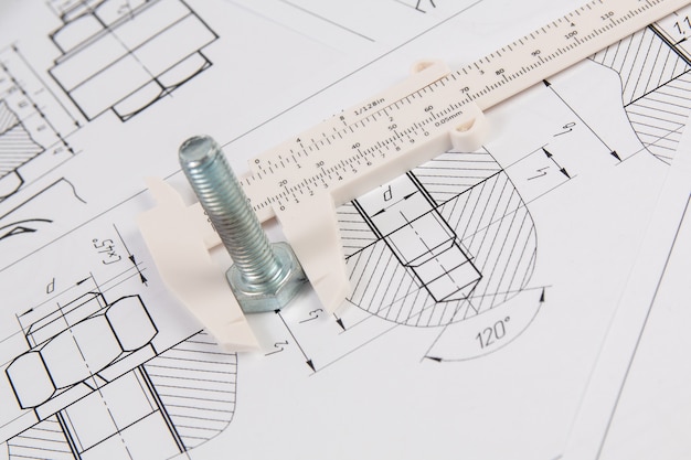 Precise measurement of metal bolt. Measuring with engineering vernier caliper.