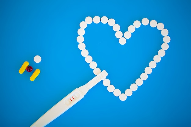 Pregnancy planning concep. Pregnancy test positive with two stripes and contraceptive pill