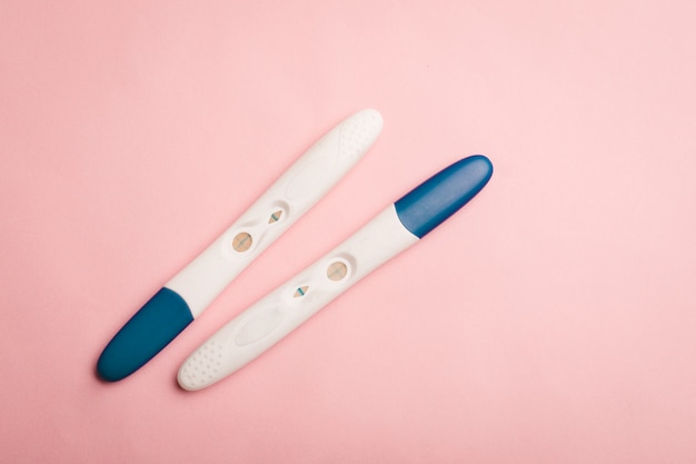 Pregnancy test on a pink background . Positive test. Pregnancy copy space.