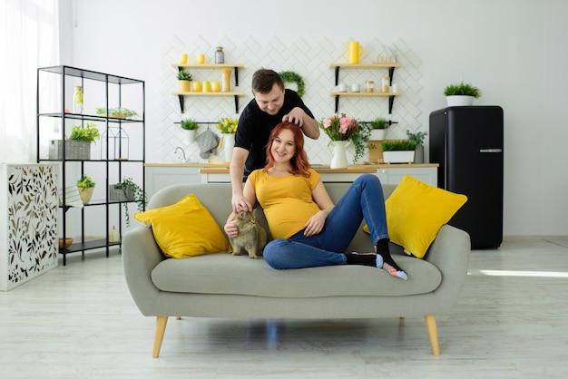 Pregnant couple have fun at home. Self isolation.