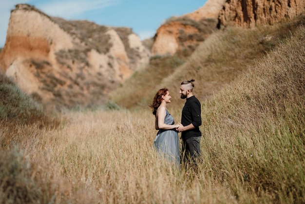 Pregnant girl and boyfriend on high hills