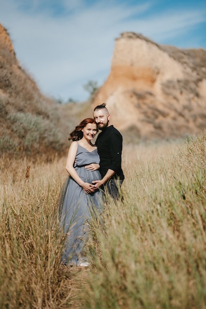 Pregnant girl and boyfriend on high hills