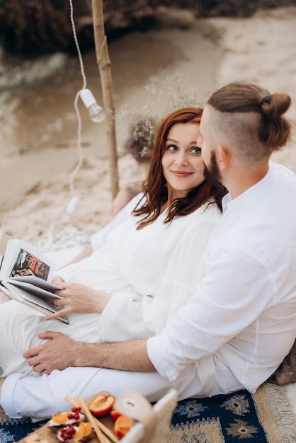 Pregnant girl and boyfriend on a picnic