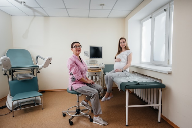 A pregnant girl is advised by a doctor after an ultrasound in the clinic. Medical examination