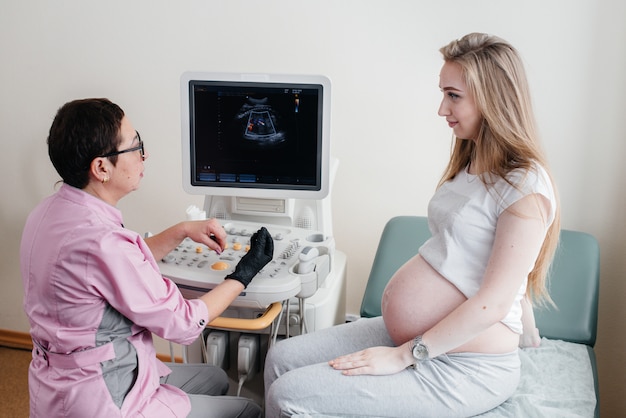 A pregnant girl is advised by a doctor after an ultrasound in the clinic. Medical examination