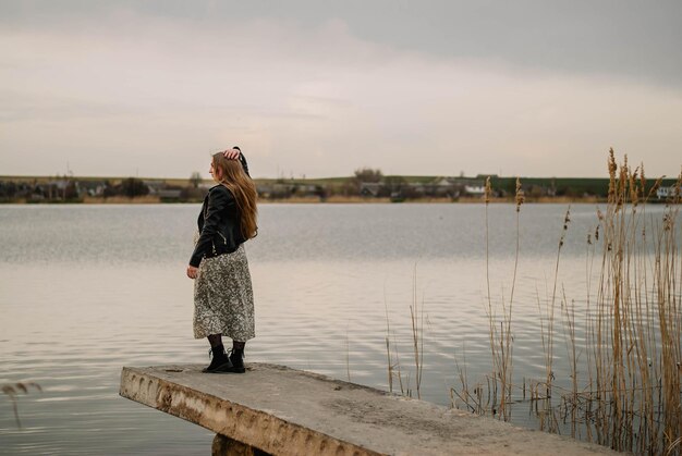 pregnant girl in nature spring reeds pregnant girl on the lake shore the girl smilesa happy mom