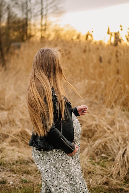 pregnant girl in nature spring reeds pregnant girl on the lake shore the girl smilesa happy mom