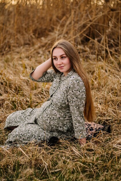 pregnant girl in nature spring reeds pregnant girl on the lake shore the girl smilesa happy mom