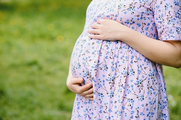 The pregnant girl on walk in city park