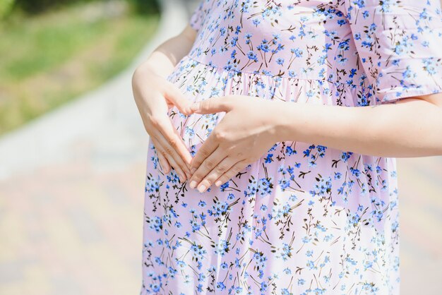 The pregnant girl on walk in city park