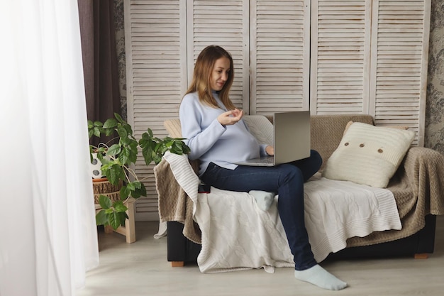 A pregnant girl works remotely at home The concept of freelancing