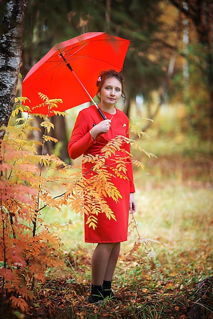 Pregnant woman in autumn park