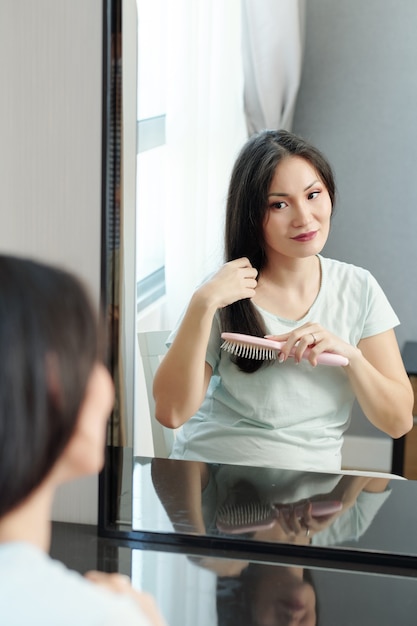 Pregnant woman brushing her hair