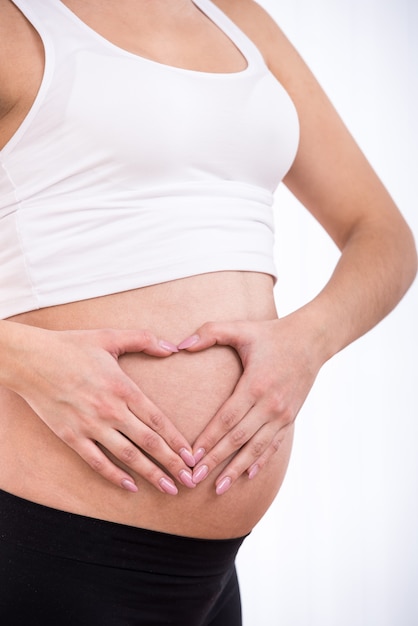 Pregnant woman, concept heart on stomach.