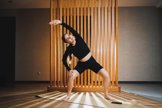 Pregnant woman doing sports on a sports mat in a sports uniform doing exercises satisfied Healthy Lifestyle Active sports pregnant woman