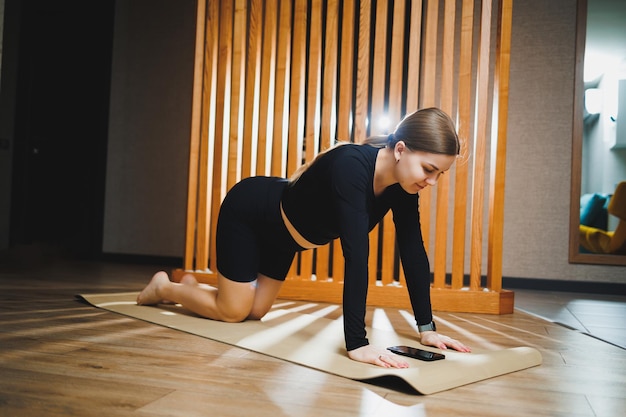 Pregnant woman doing sports on a sports mat in a sports uniform doing exercises satisfied Healthy Lifestyle Active sports pregnant woman