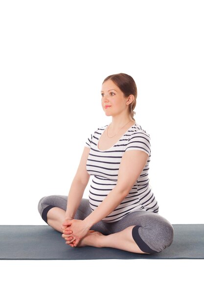 Pregnant woman doing yoga asana Baddha Konasana