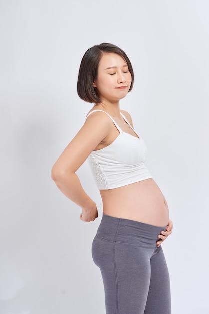 A pregnant woman feels pain Her back hurts Pregnant woman at home Pregnant stress