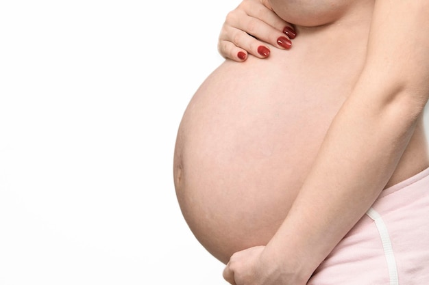 A pregnant woman has a white background and the word pregnancy on her belly.