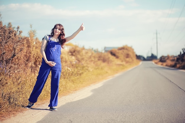 Pregnant woman hitchhiking the car