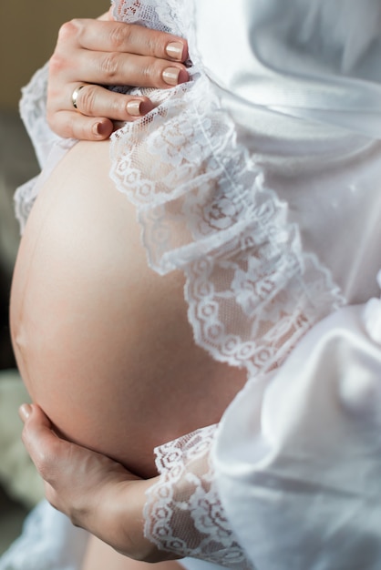 Pregnant woman holding belly