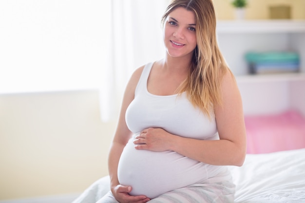 Pregnant woman holding her bump