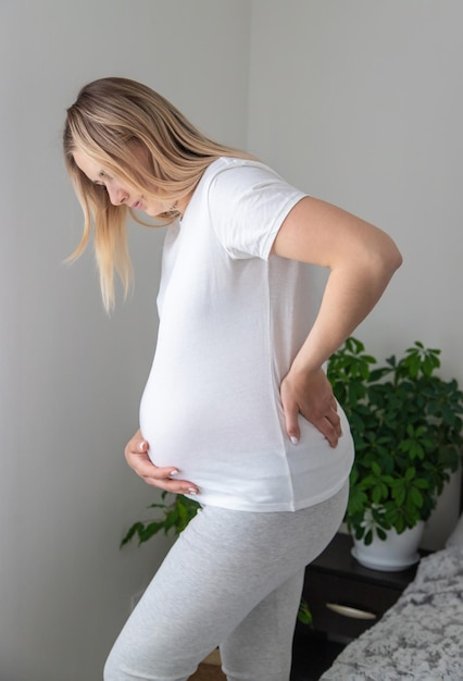 Pregnant woman hurts her back Selective focus