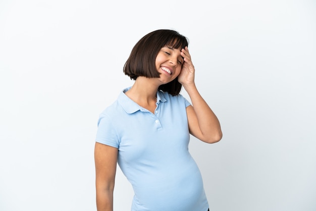 Pregnant woman over isolated white background smiling a lot